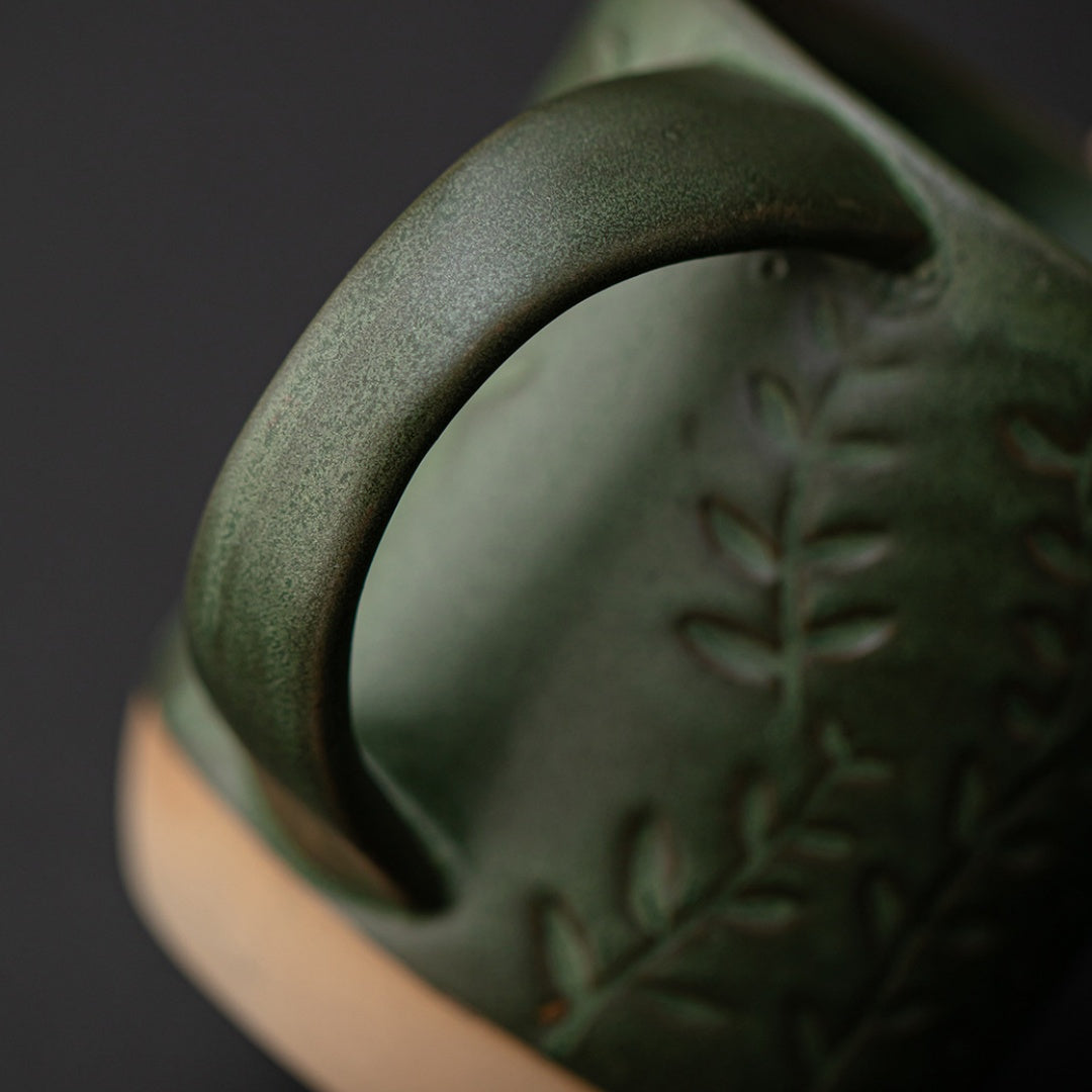 Close-up detail of the small leaf relief and rustic base on Ceravor mug