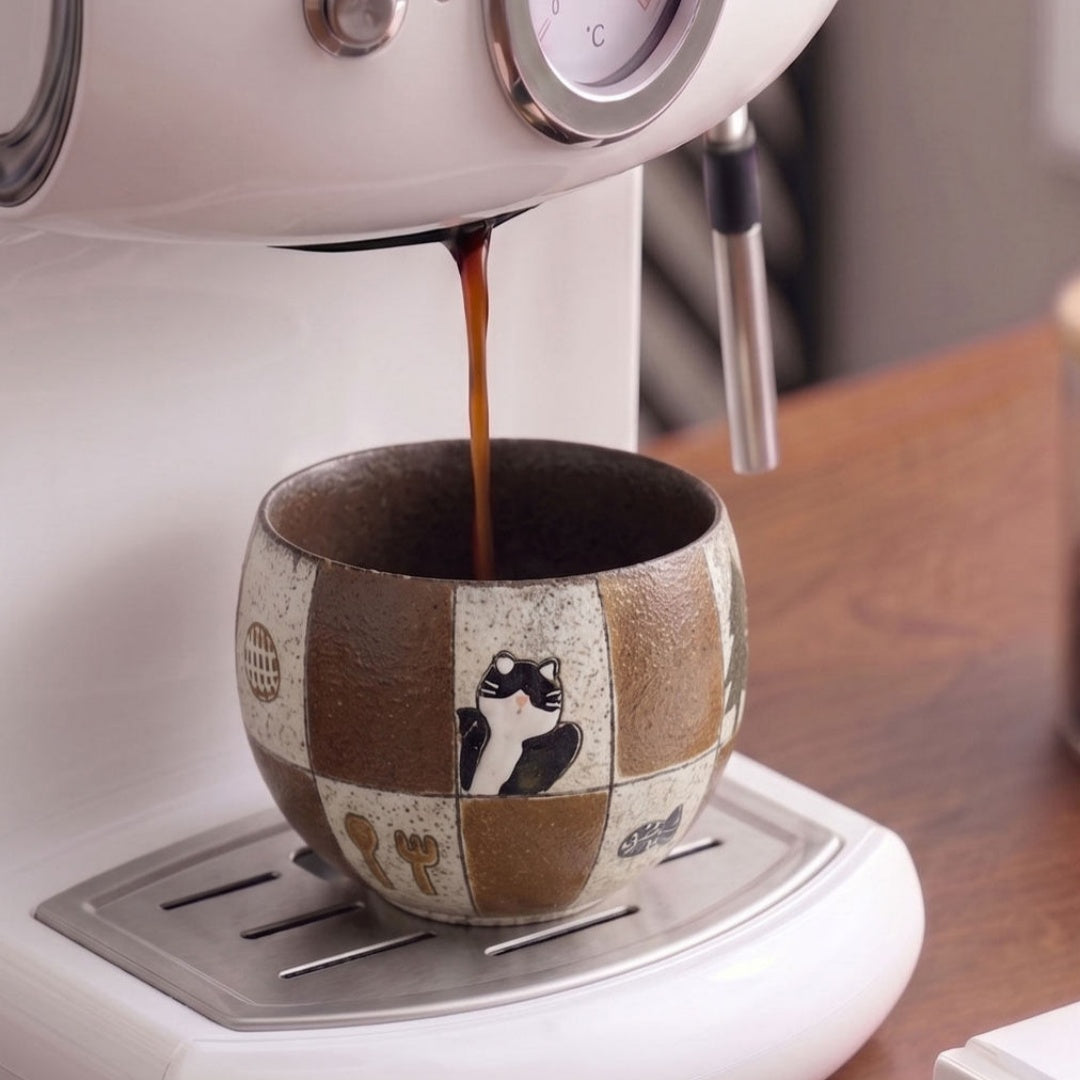 Hand holding Ceravor cat ceramic cup with swan latte art