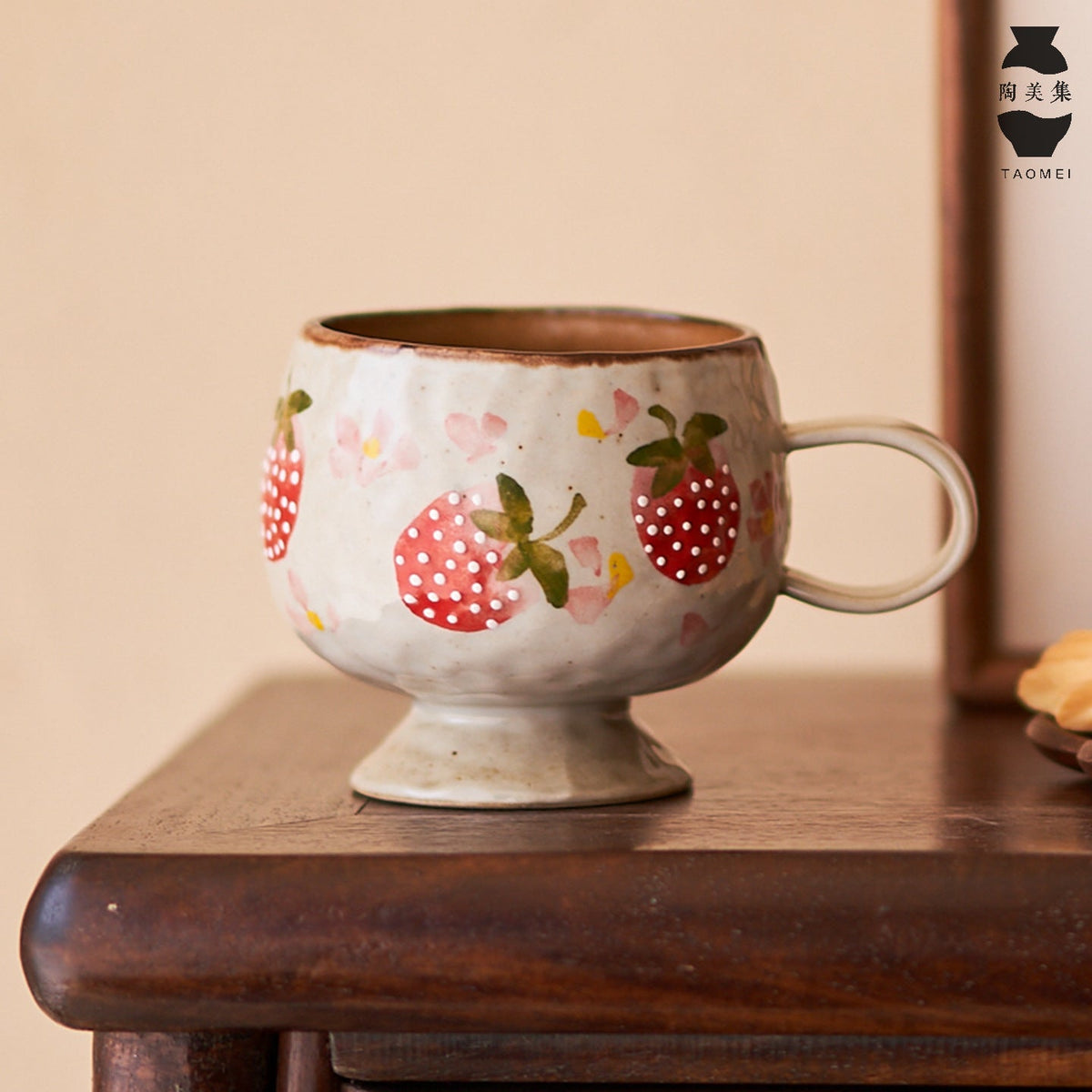 Side view of Ceravor hand-painted strawberry mug with footed base