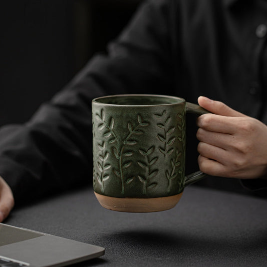 Ceravor large and small leaf relief green ceramic mugs on a table