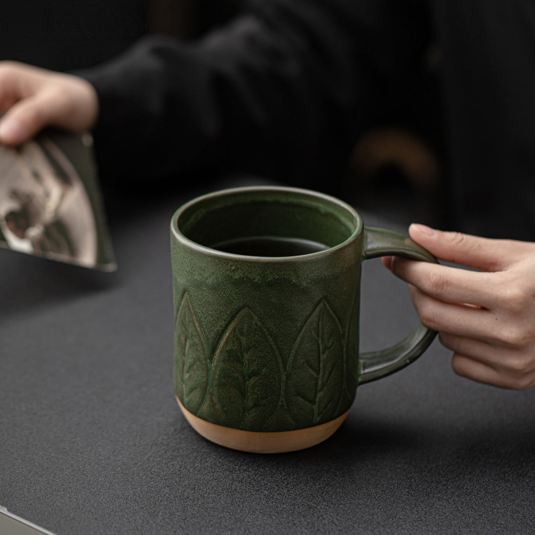 Ceravor small leaf relief green ceramic mug filled with dark coffee