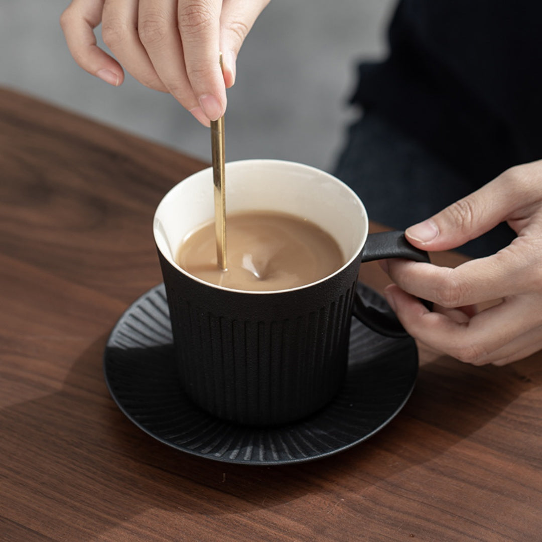 Ceravor green ribbed ceramic coffee mug on a white desk with coffee