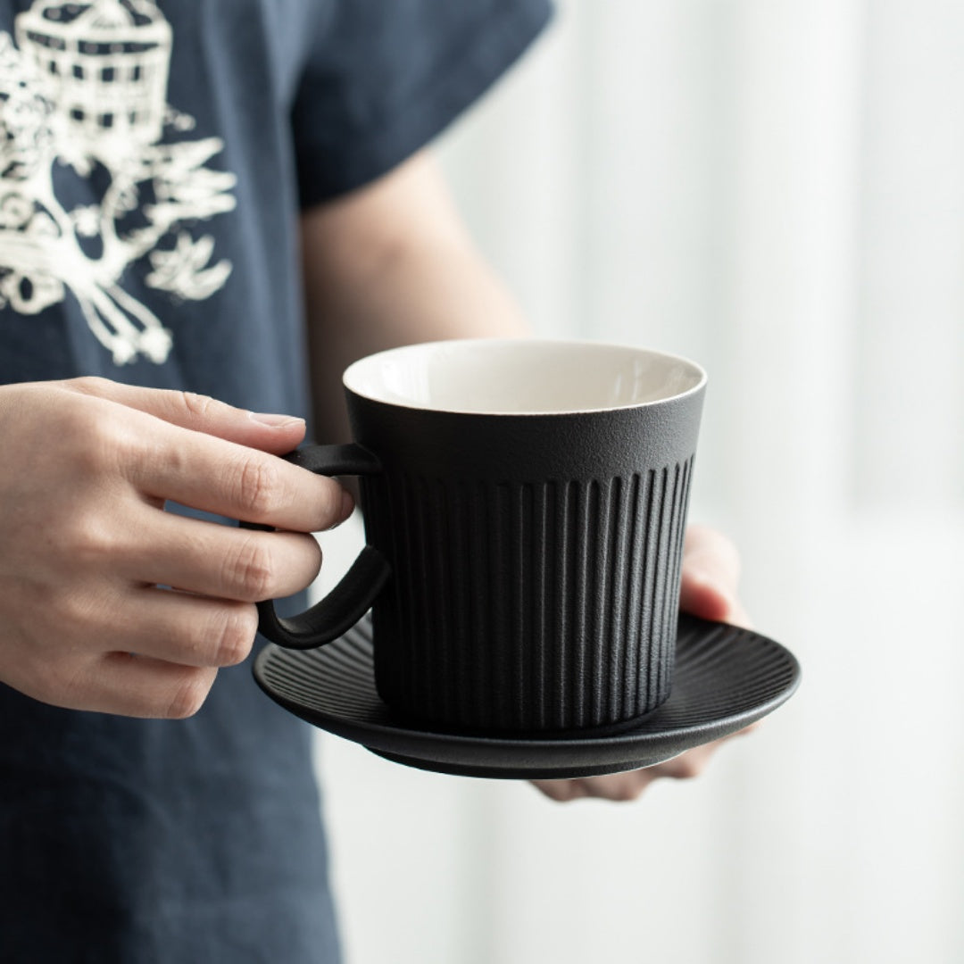Close-up of the wooden handle on the Ceravor ribbed ceramic coffee mug