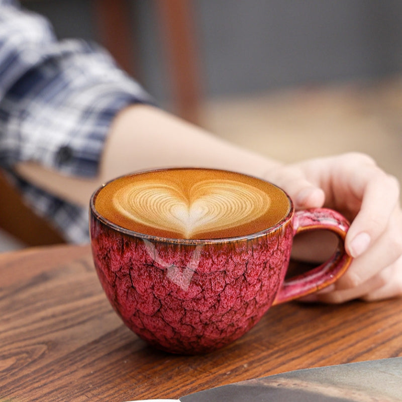Hand holding Ceravor crimson crackle glaze ceramic mug