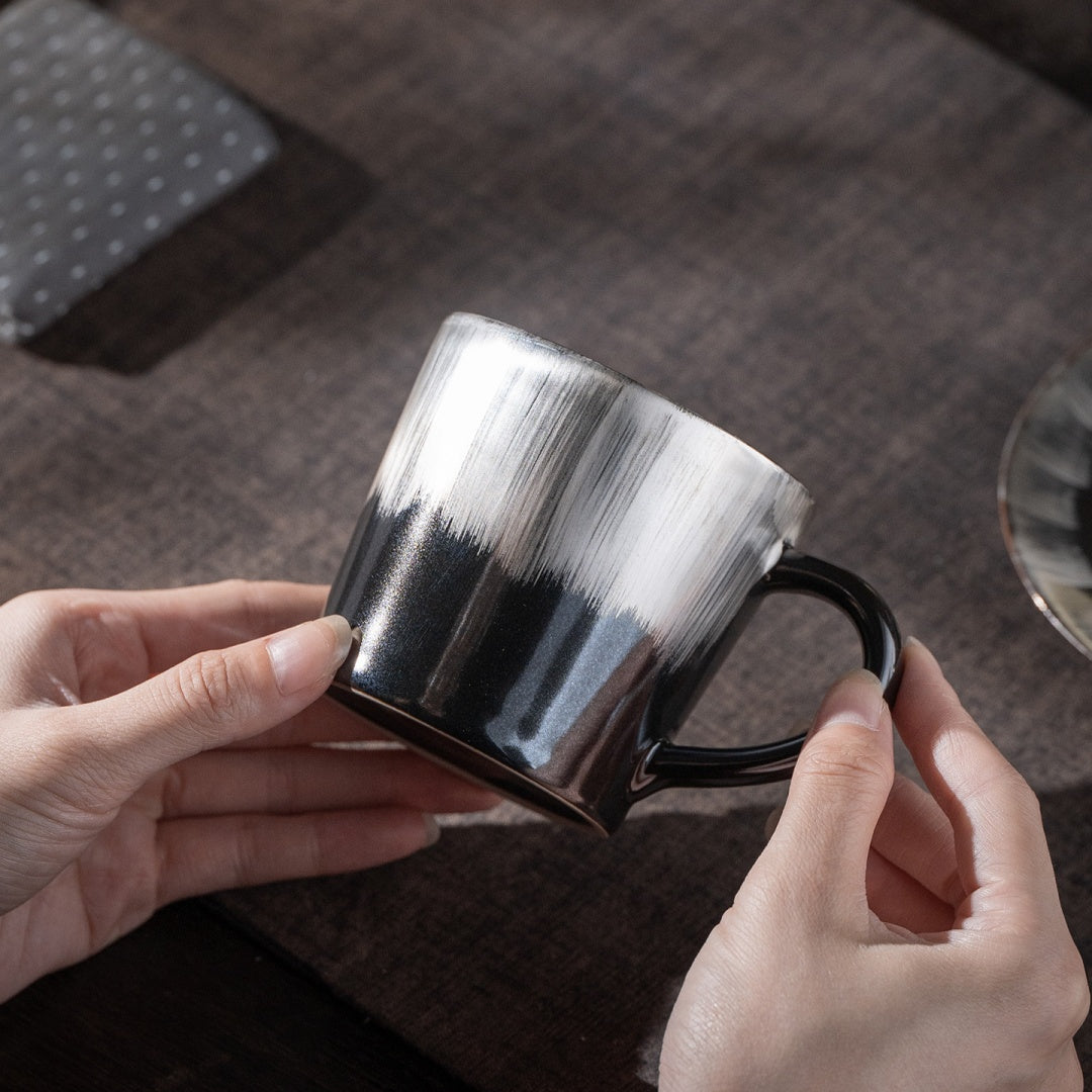 Hand touching the saucer of the Ceravor Linglong white ceramic cup